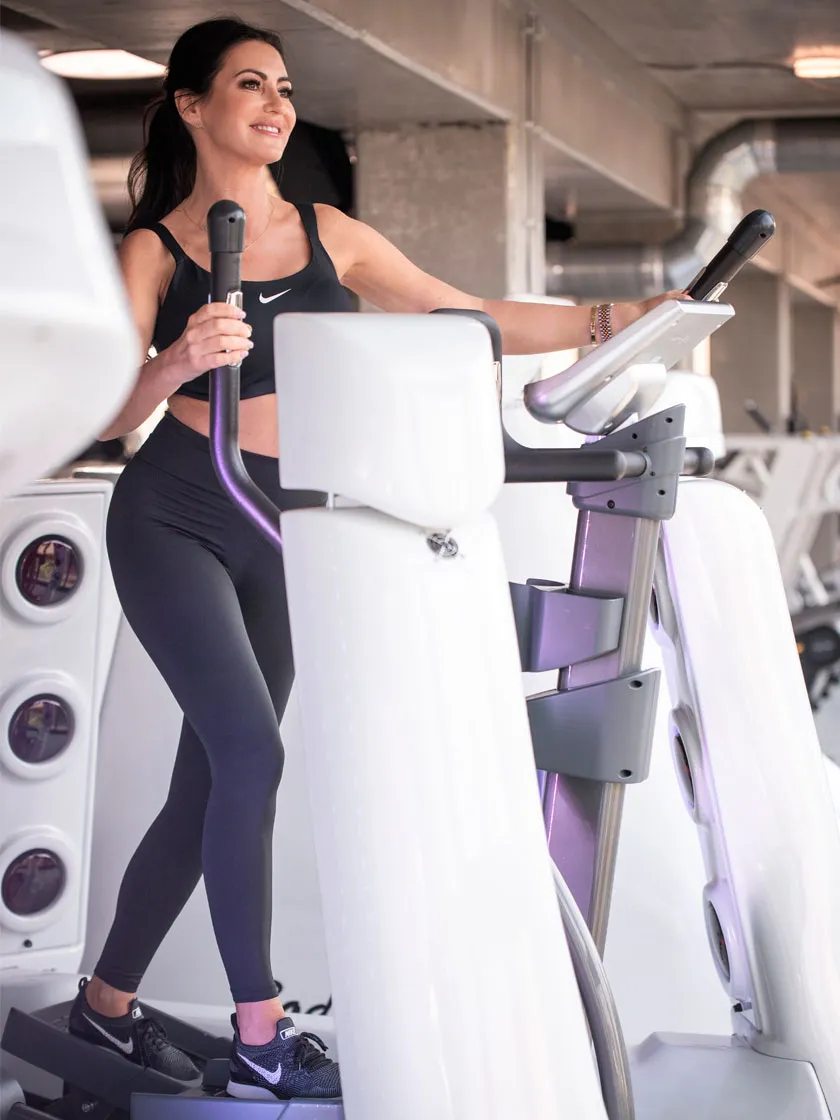 Woman using a Body Space® elliptical trainer with infrared technology