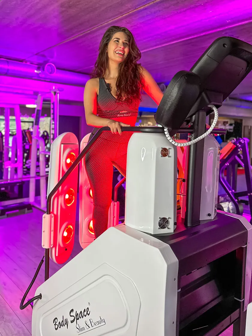 Woman in black workout wear using the Body Space® InfraRed Stair Climber – cardio stepper with red light therapy